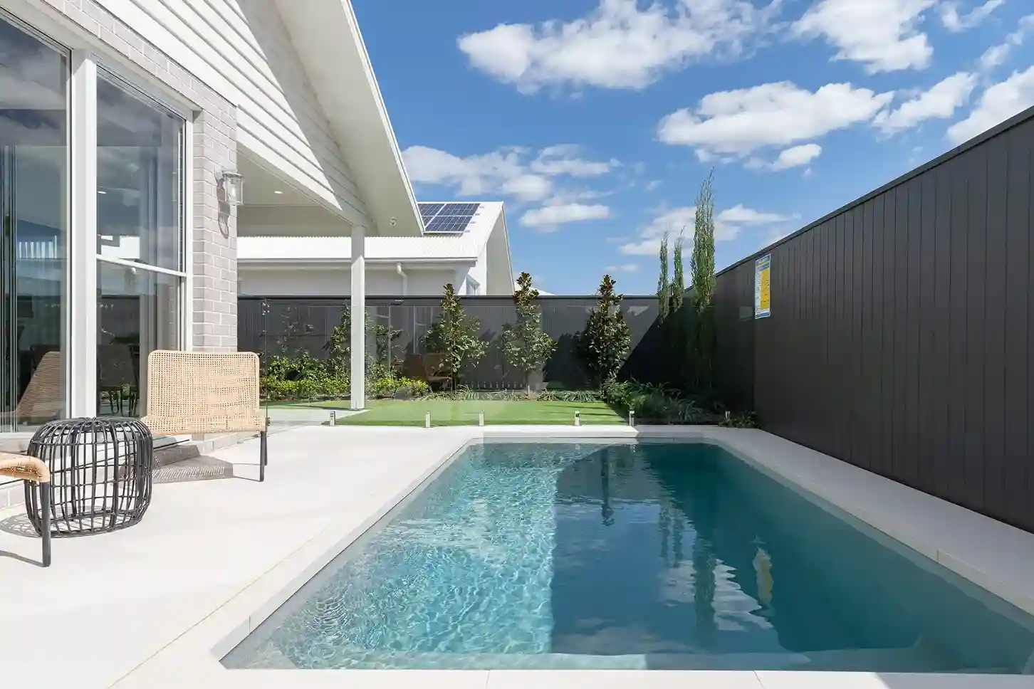 Backyard plunge pool with patio seating.