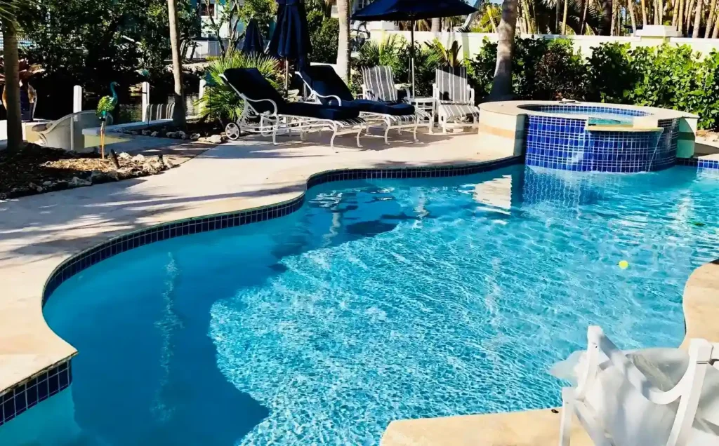 A luxury fiberglass pool featuring a spa and modern lounge area, highlighting designs from top fiberglass pool manufacturers.