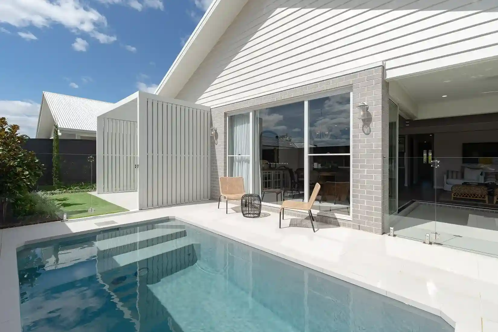 Plunge pool with glass fencing and seating