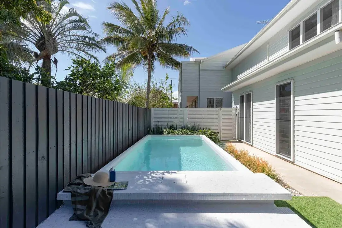 Plunge Max Pool in a tropical Florida backyard with palm trees.