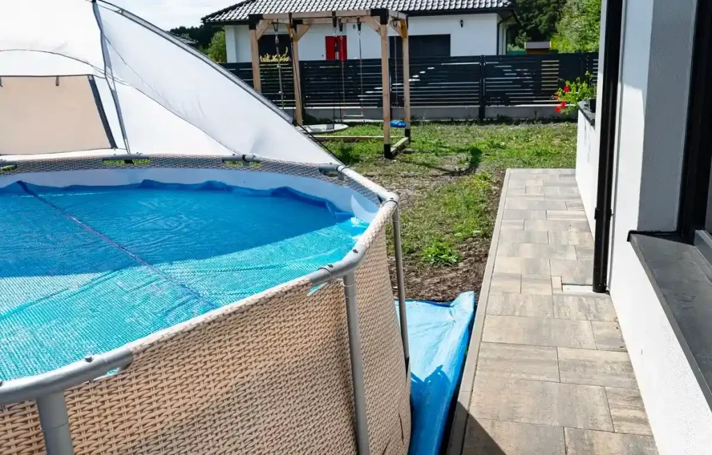 A large above-ground pool with surrounding fence ideas, showcasing a spacious outdoor setup for safety and privacy.