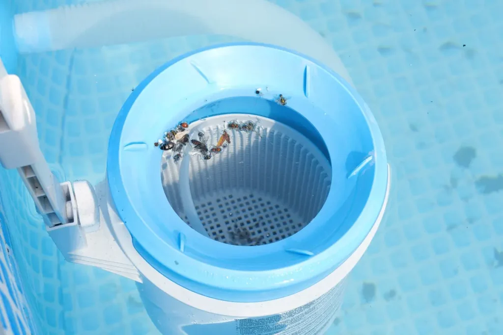 Close-up view of an above ground pool pump and filter collecting debris for clean and clear pool water.