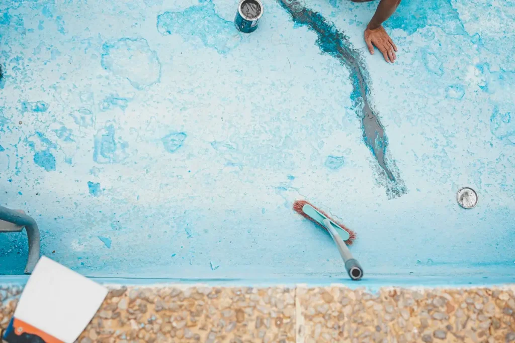 In-progress concrete pool repair showing surface restoration and crack sealing