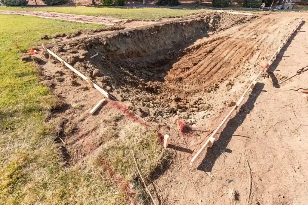 Excavation process for fiberglass pool installation in Florida, showcasing a partially dug backyard pool area.