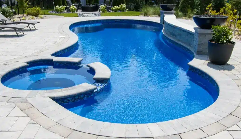 Allure 15.30 fiberglass pool with built-in spa and curved patio